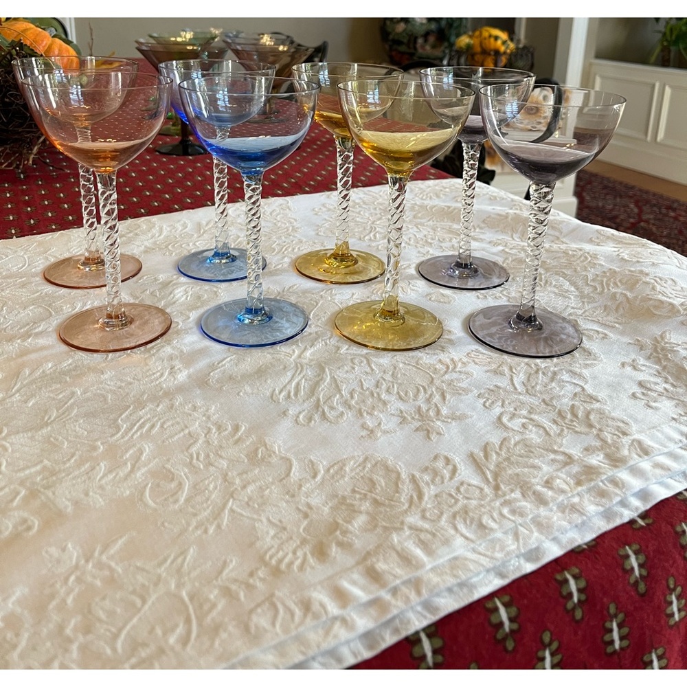 Vintage colored glass apprentice or wine glasses with twisted stems.